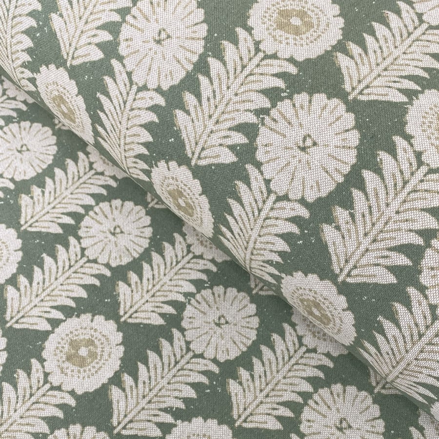A folk-inspired block print style design with a stylised floral motif in green. A versatile mid scale design suitable for curtains and blinds.