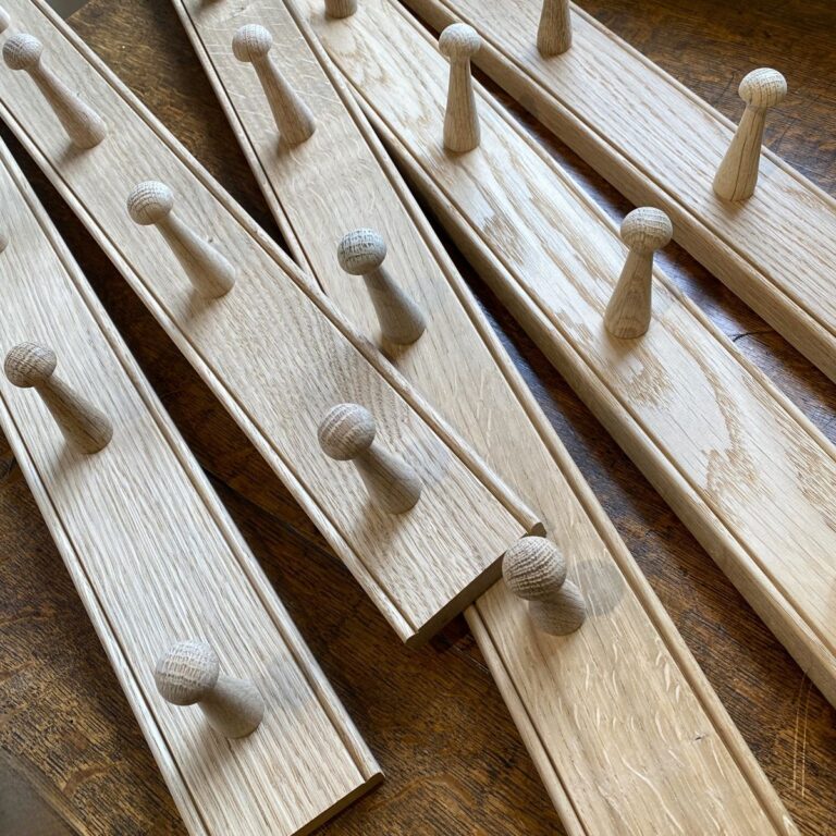 A stack of oak hook rails from Tinsmiths