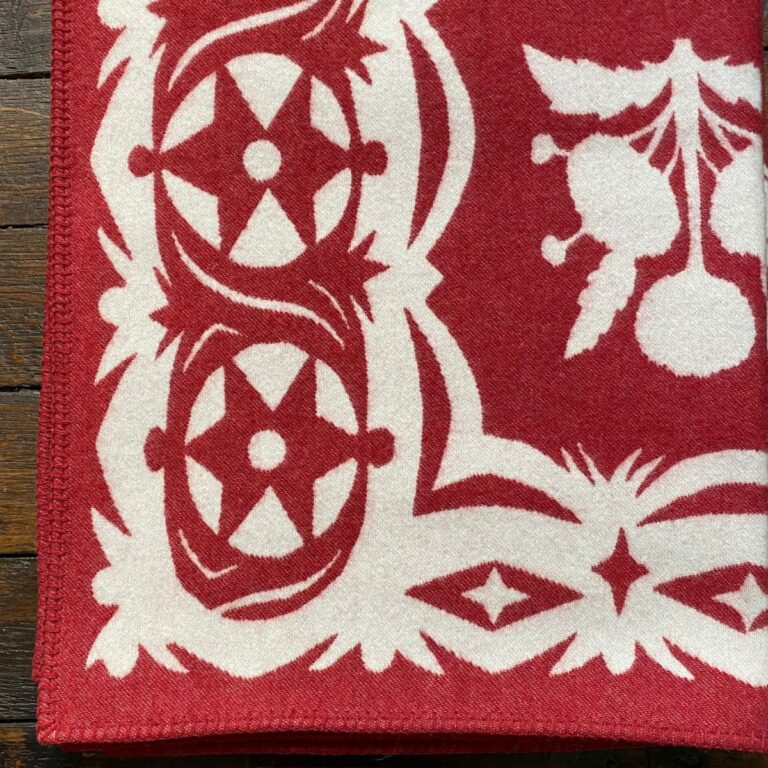 red blanket with papercut flower design