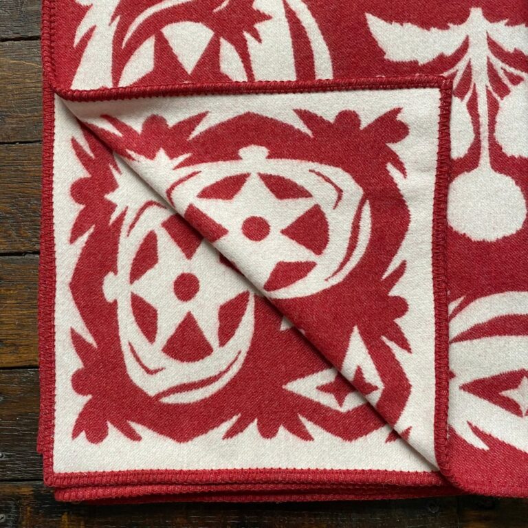 red blanket with papercut flower design