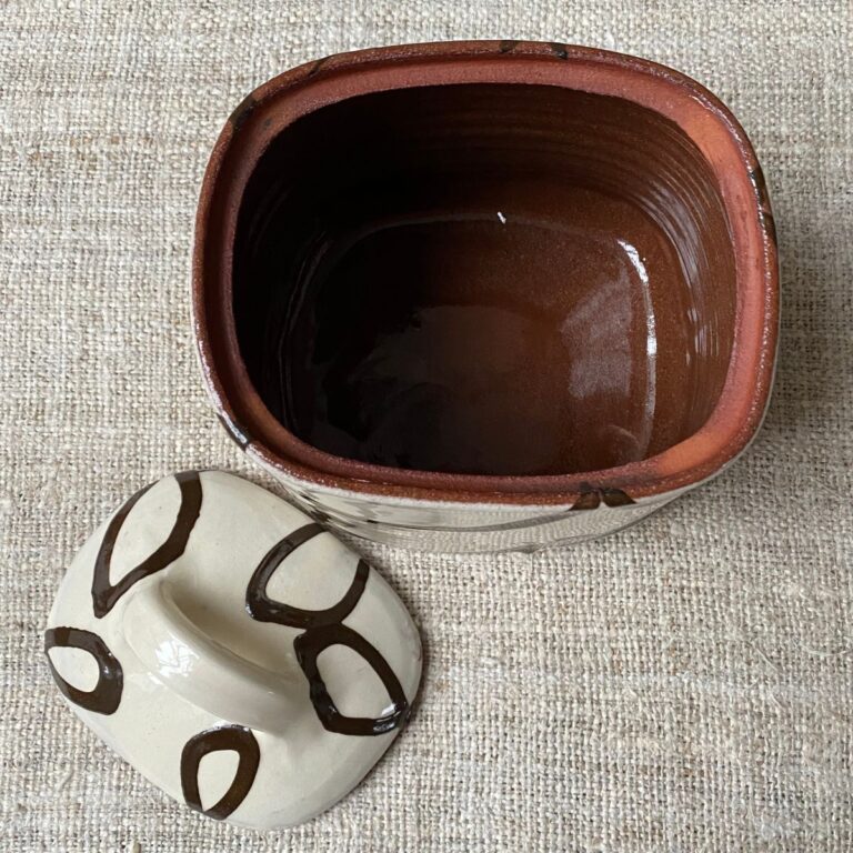 Erica Taylor Low cream slipware jar with lid next to it