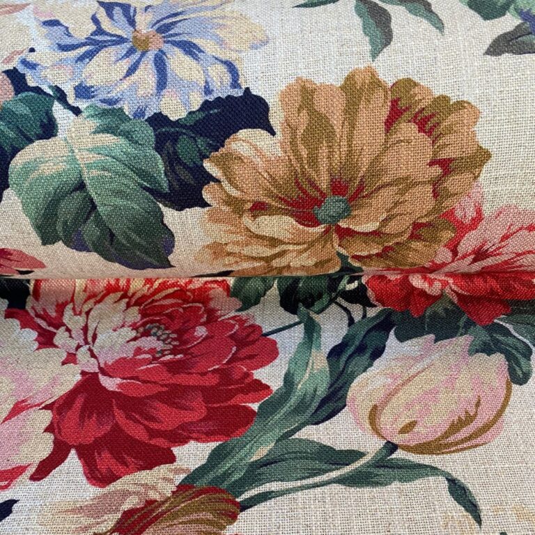 Tinsmiths Extra Wide Grandiflora fabric on a roll in red, blue & gold.