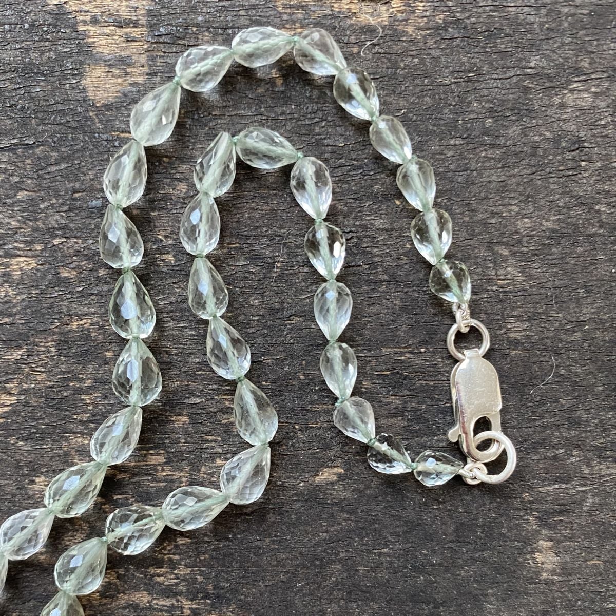 Amethyst & Silver beaded necklace on a wooden background