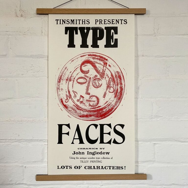Type Faces Letterpress Poster on a white wall