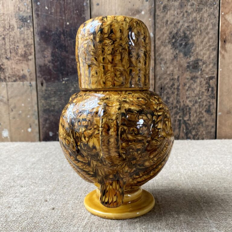 Carole Glover slipware glazed Ozzy Owl against a wooden background