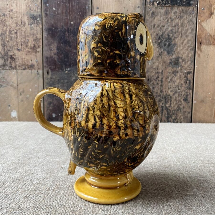 Carole Glover slipware glazed Ozzy Owl against a wooden background