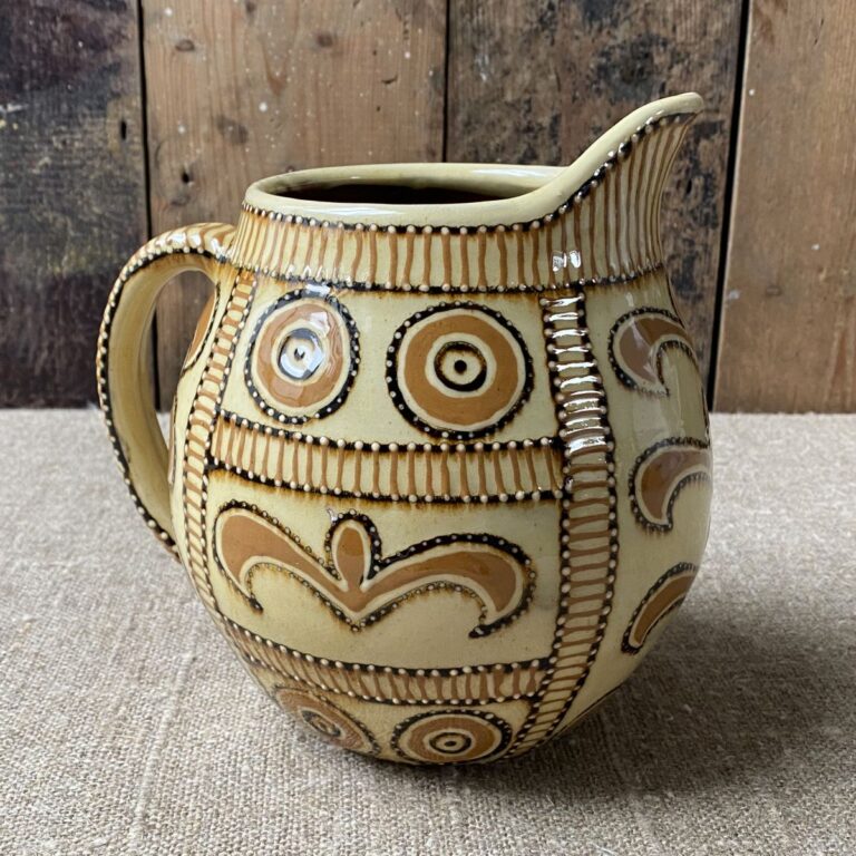 Carole Glover Slipware Noggin Jug against wooden background