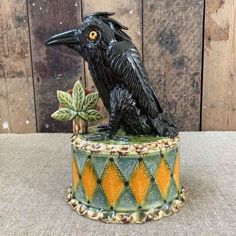 Ceramic slipware black crow on a patterned plinth by Paul Young