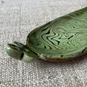 Patia Davis extra long oval platter with green glaze on linen backcloth