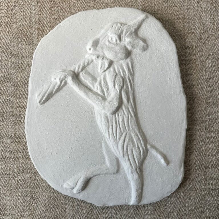 Pargetted lime plaster relief featuring goat with a pipe