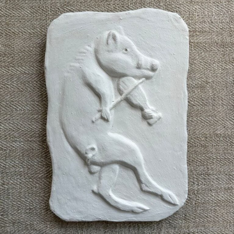 Pargetted lime plaster relief featuring boar with a fiddle