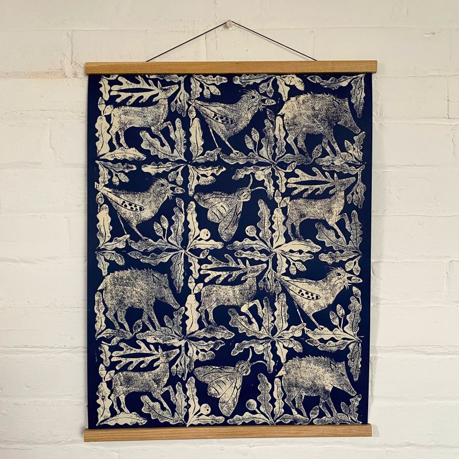 Sarah Burns Patterns beast poster hanging on a white brick wall.
