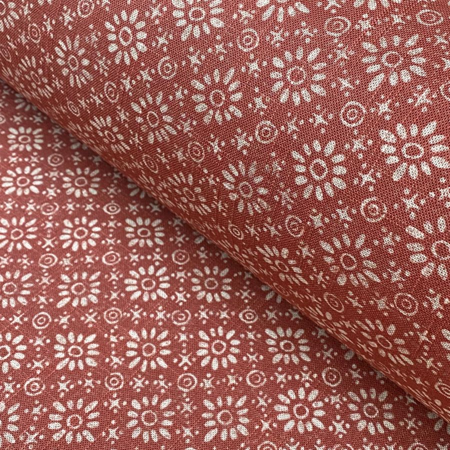 Fabric roll with red, small scale daisy pattern
