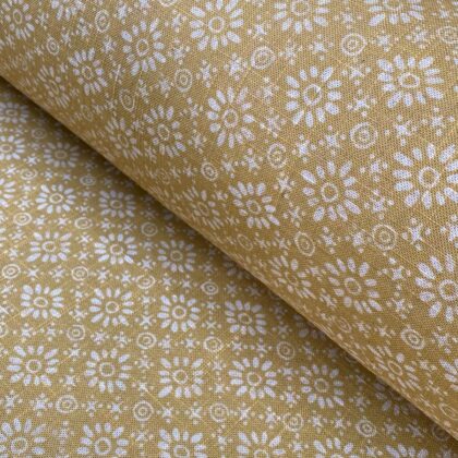 Fabric roll with mustard yellow, small scale daisy pattern