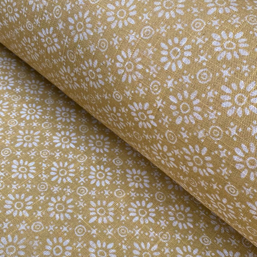 Fabric roll with mustard yellow, small scale daisy pattern