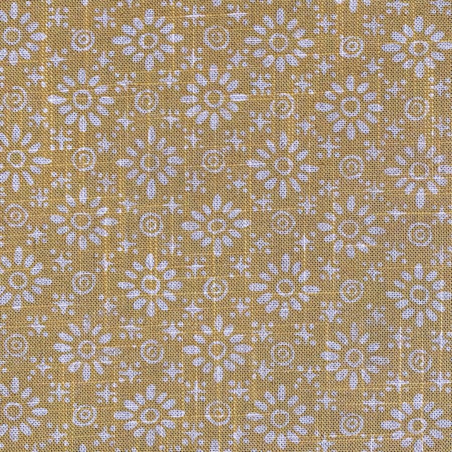 Fabric roll with mustard yellow, small scale daisy pattern