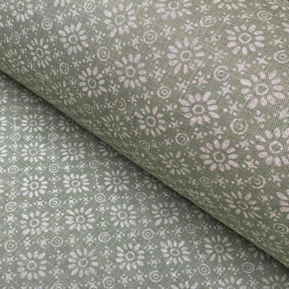 Roll of fabric with a sage green floral design