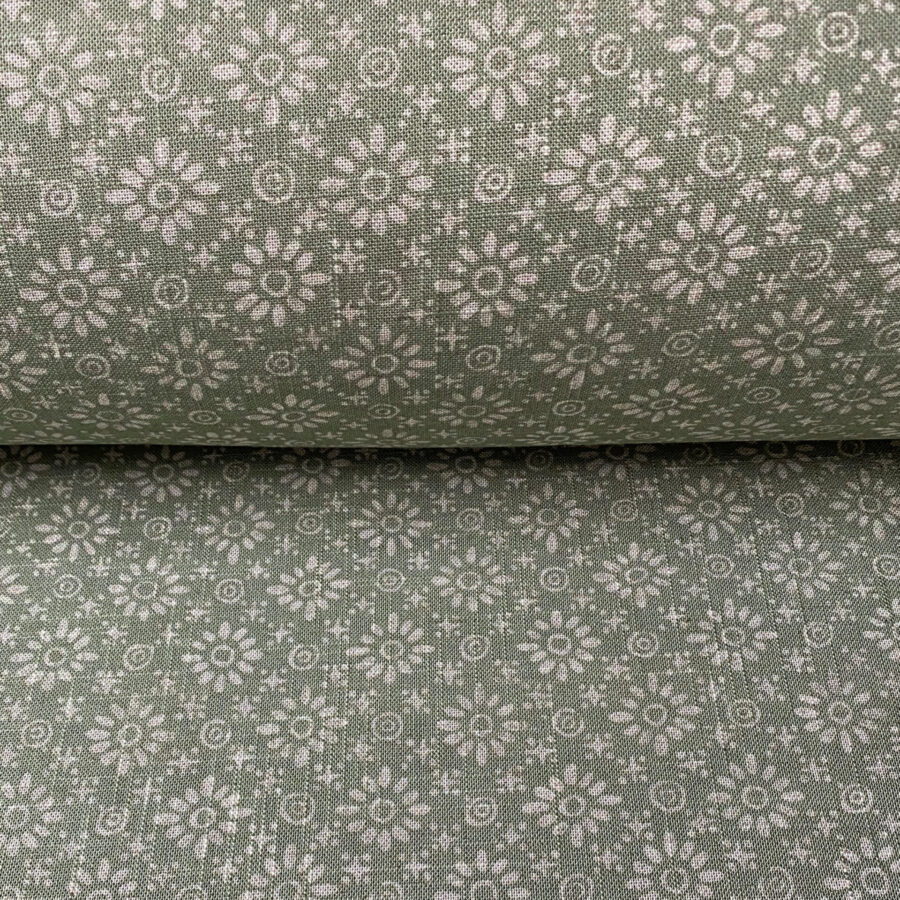 Roll of fabric with a sage green floral design